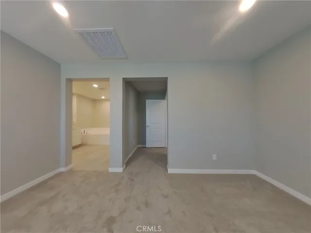 a view of an empty room and closet area