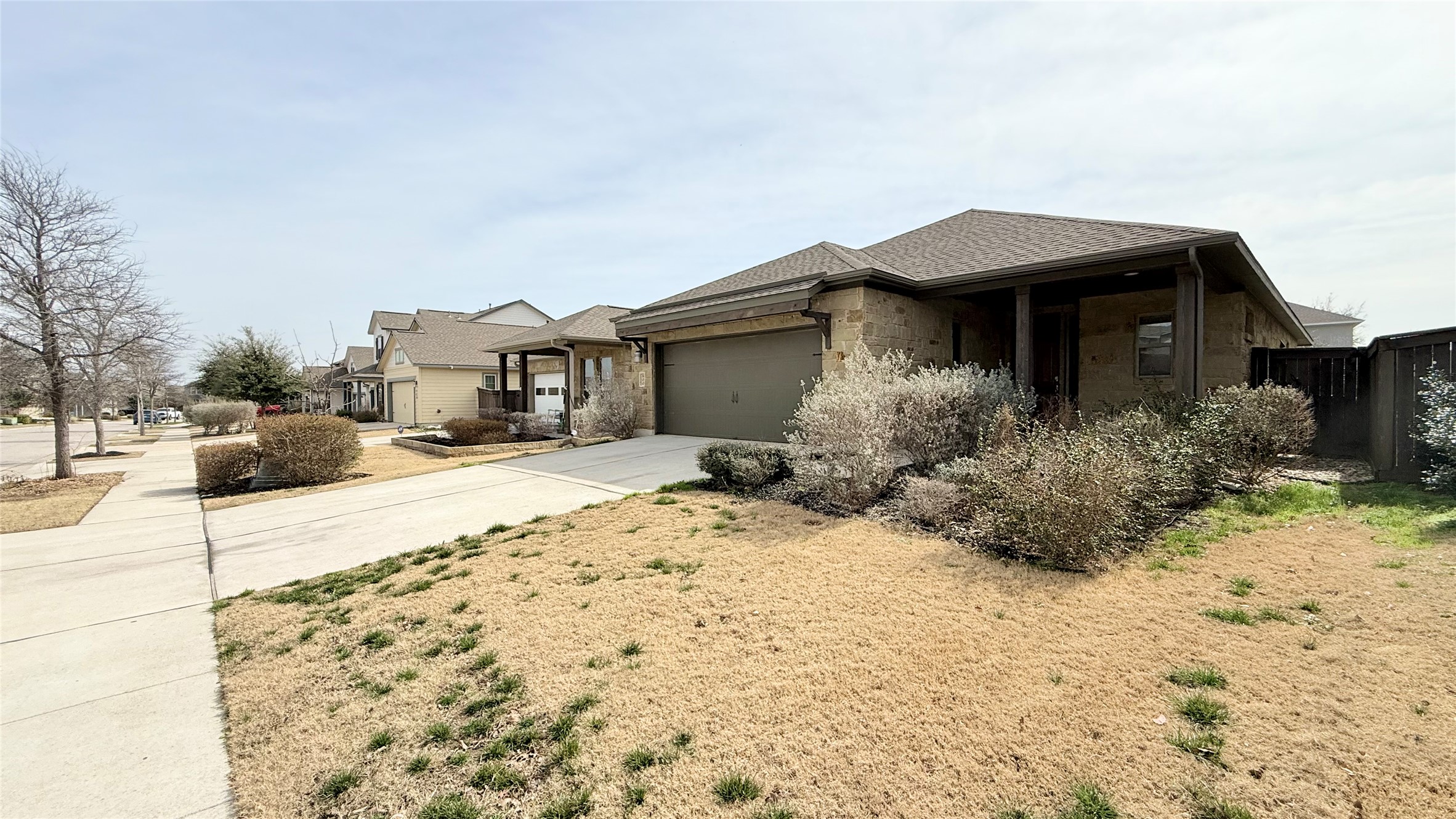 600 Golden Glory Road Leander, TX 78641 - Photo 3 of 21 View of front facade with driveway, an attached garage, and stone siding