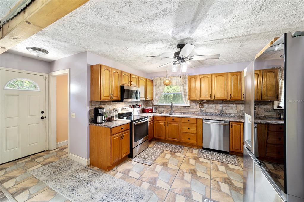 15755 Southwest 90th Avenue Dunnellon, FL 34432 - Photo 22 of 55 a kitchen with stainless steel appliances granite countertop a stove cabinets and refrigerator