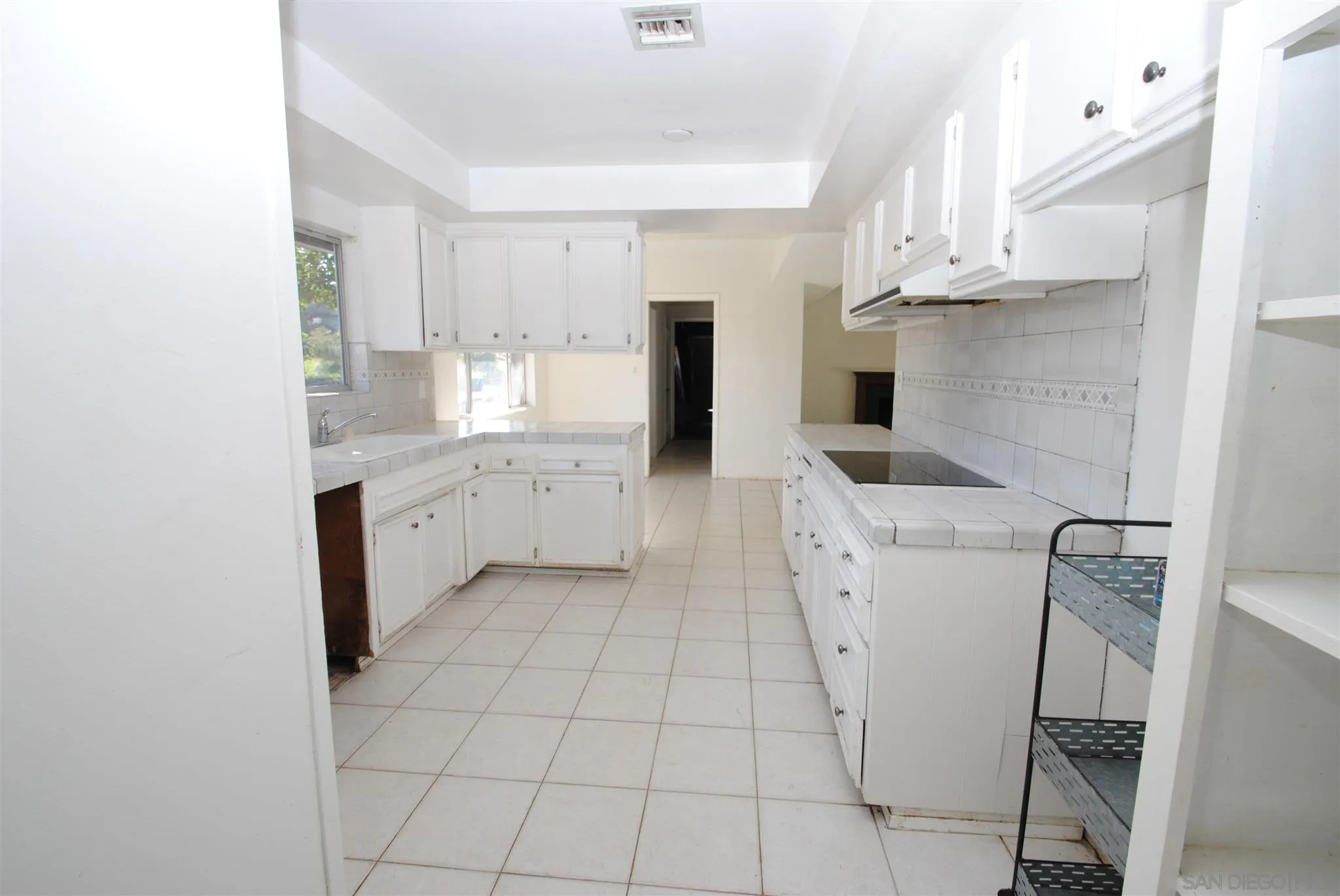 4826 New Ranch Road El Cajon, CA 92020 - Photo 14 of 19 a kitchen with a sink a stove cabinets and counter space