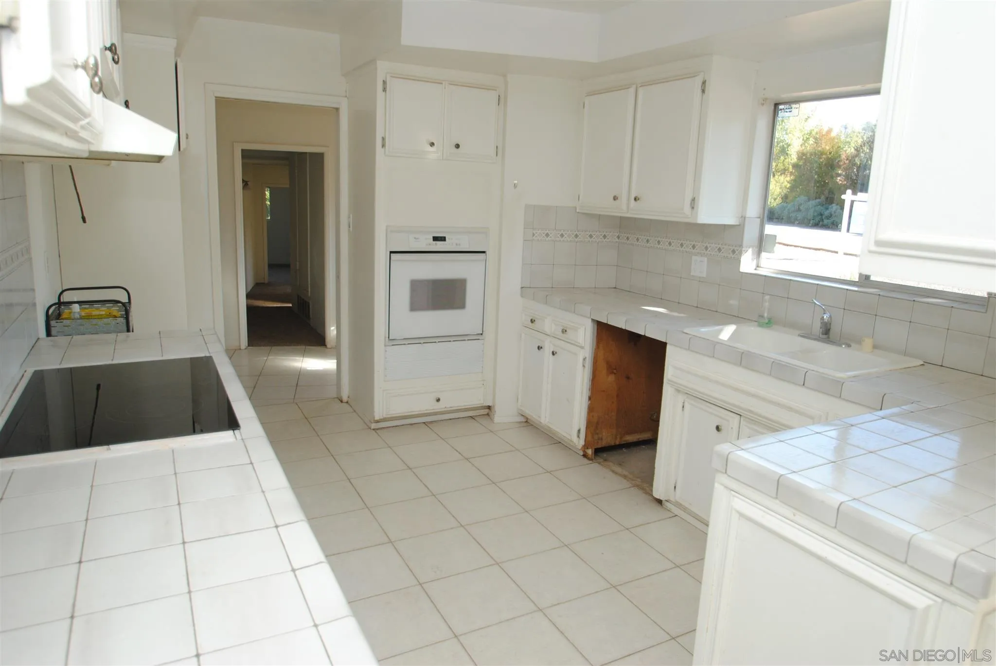 4826 New Ranch Road El Cajon, CA 92020 - Photo 5 of 19 a kitchen with a sink a stove and cabinets