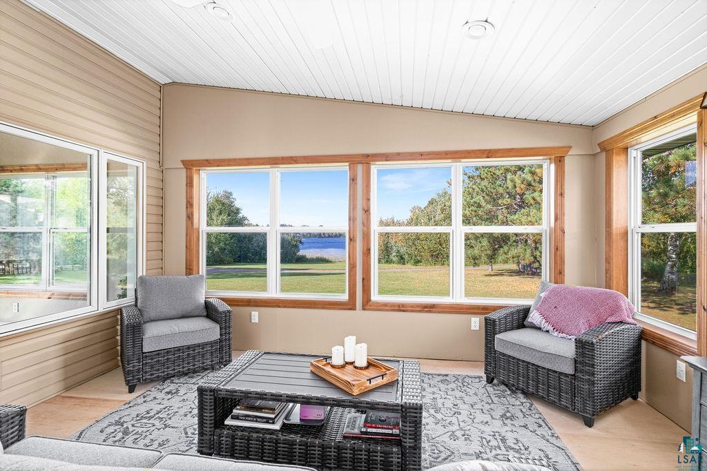 6638 Tabako Road Wright, MN 55798 - Photo 4 of 34 Sunroom featuring wood finished floors, plenty of natural light, wooden walls, and a vaulted wood ceiling