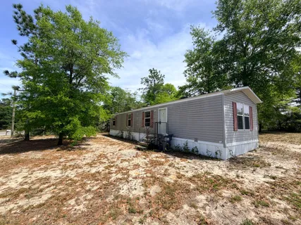 a view of a barn in the middle of a yard