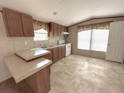 a kitchen with a stove a sink and a refrigerator