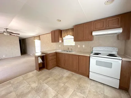 a kitchen with a stove sink and a refrigerator