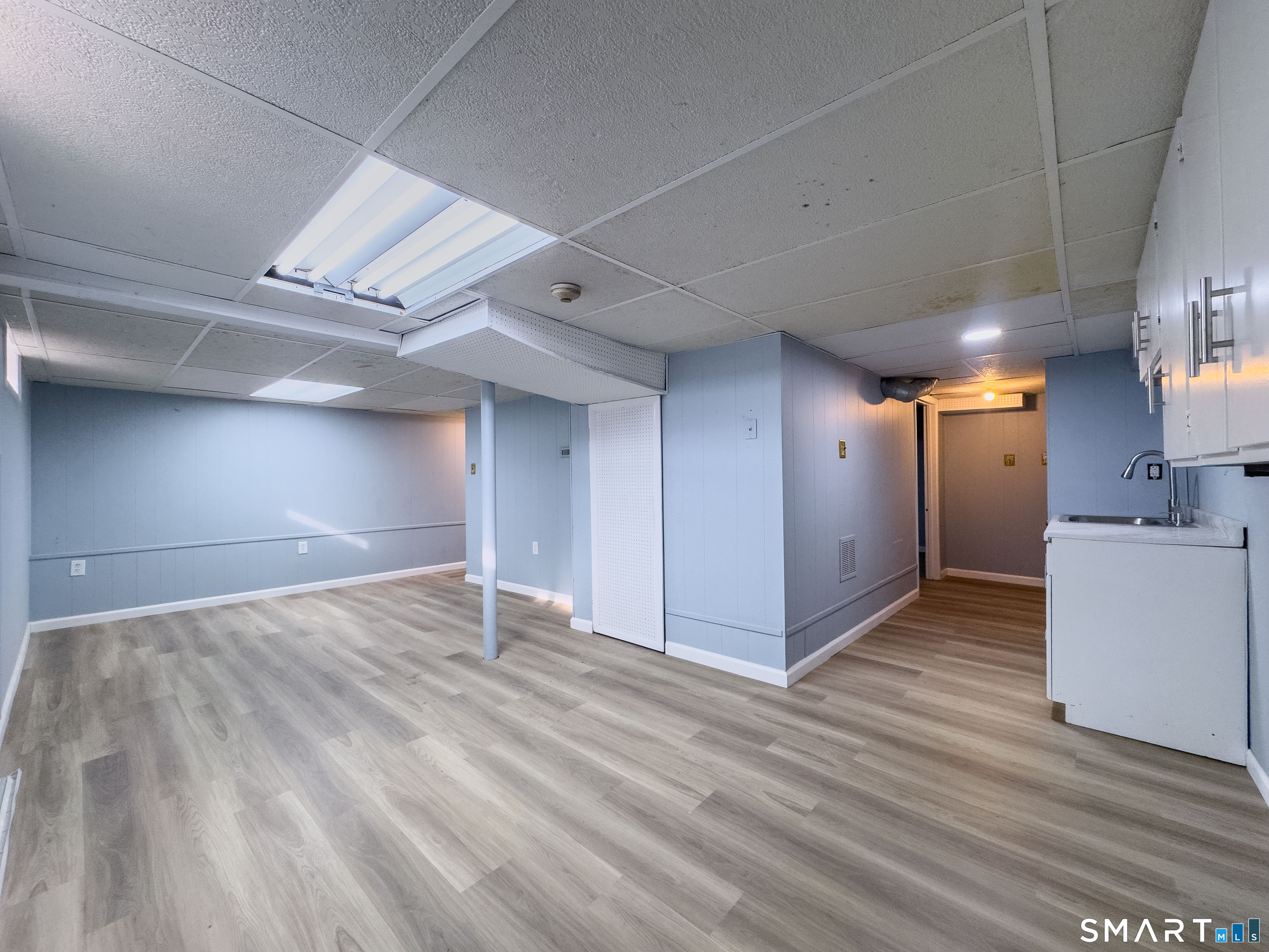 167 North Hoadley Street Naugatuck, CT 06770 - Photo 11 of 17 a view of an empty room with wooden floor and a kitchen