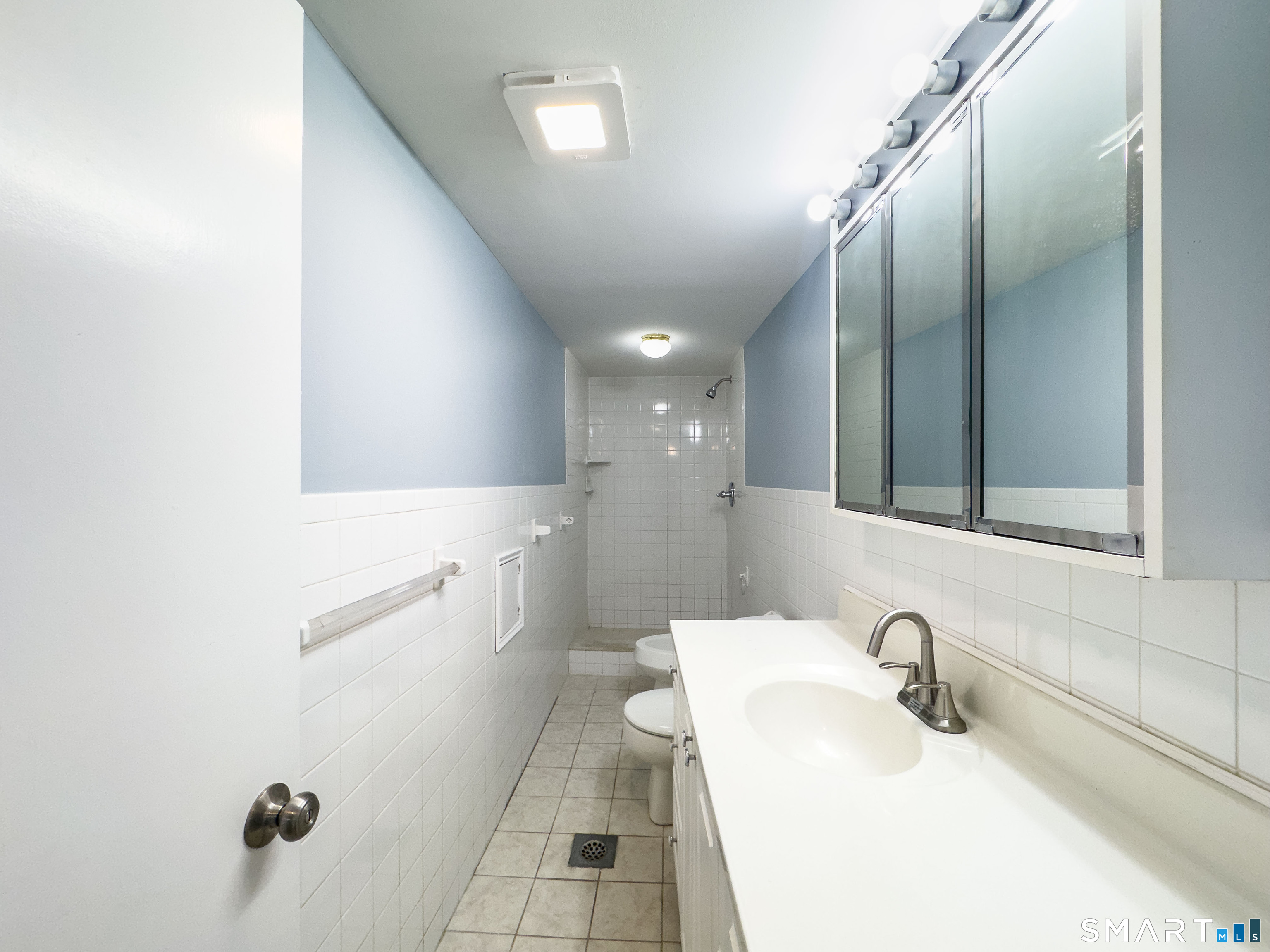167 North Hoadley Street Naugatuck, CT 06770 - Photo 12 of 17 a bathroom with a sink and mirror with toilet