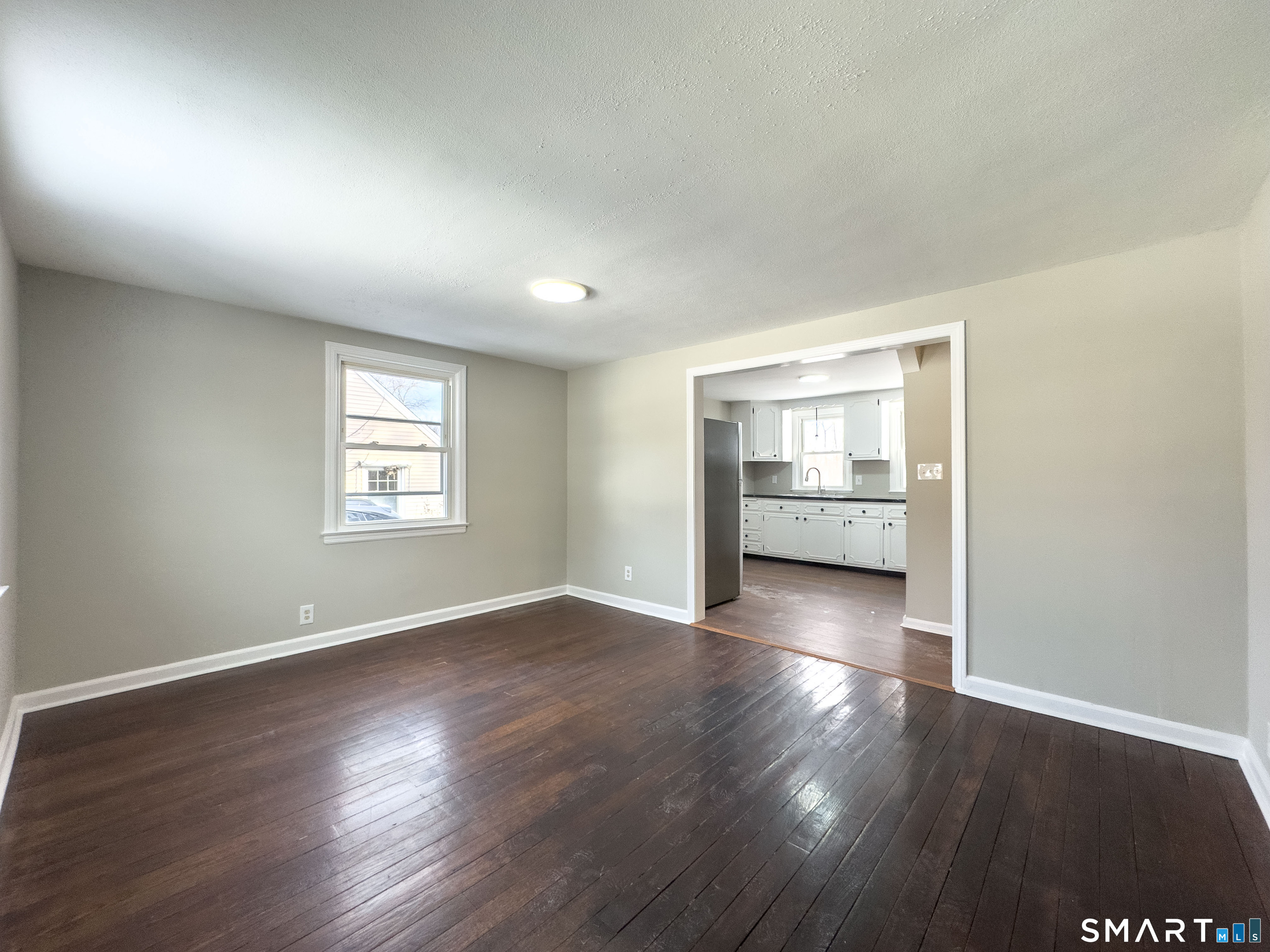 167 North Hoadley Street Naugatuck, CT 06770 - Photo 4 of 17 an empty room with wooden floor and windows
