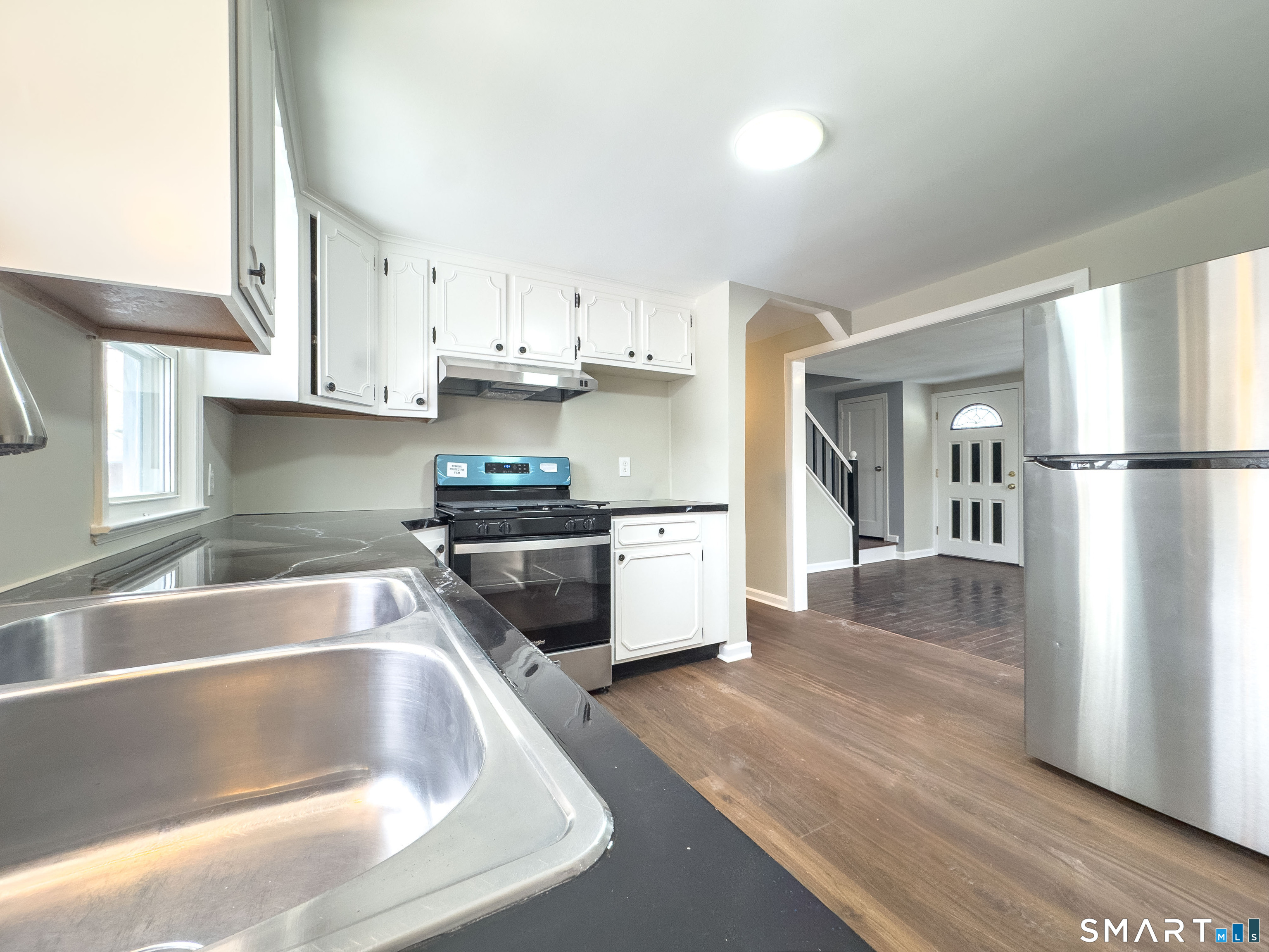 167 North Hoadley Street Naugatuck, CT 06770 - Photo 6 of 17 a kitchen with granite countertop a refrigerator and a sink