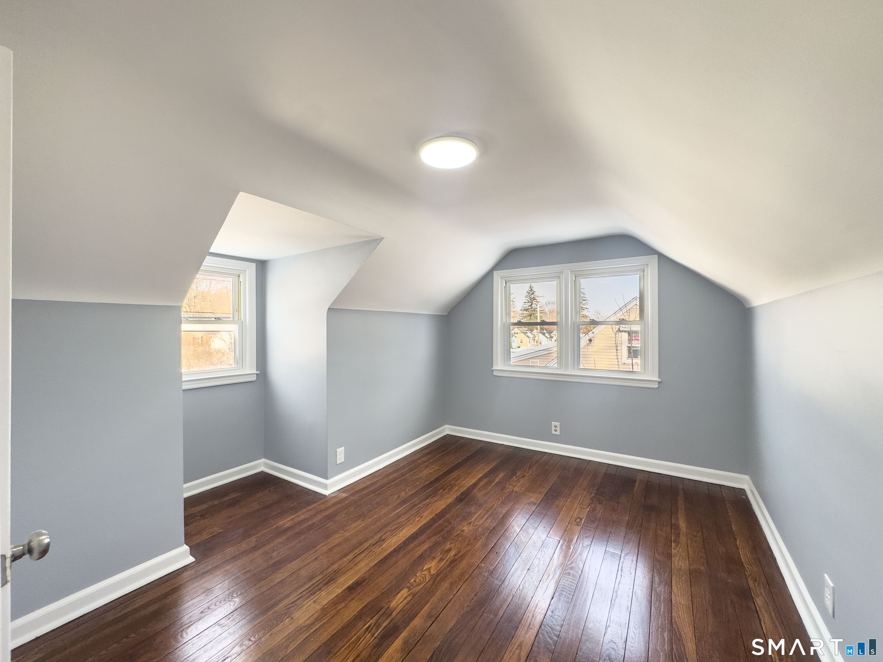167 North Hoadley Street Naugatuck, CT 06770 - Photo 9 of 17 an empty room with wooden floor and windows