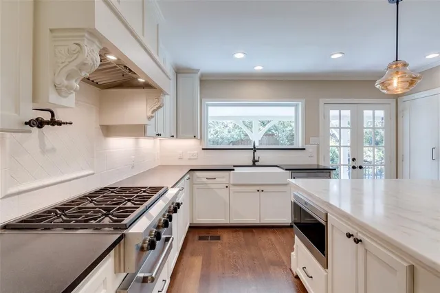 a kitchen with a sink stove and cabinets