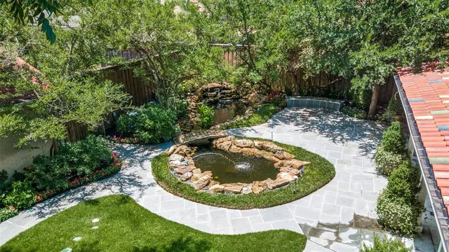 a view of a swimming pool with a sink and trees in the background