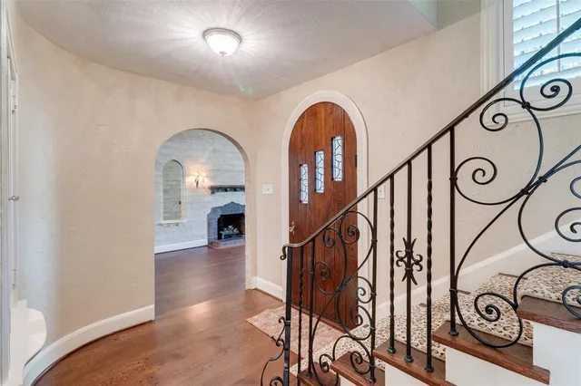 a view of entryway and hall with wooden floor