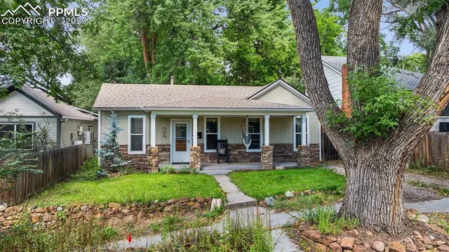 a front view of a house with garden and porch