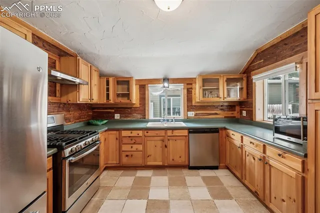 a kitchen with stainless steel appliances granite countertop a stove and a sink