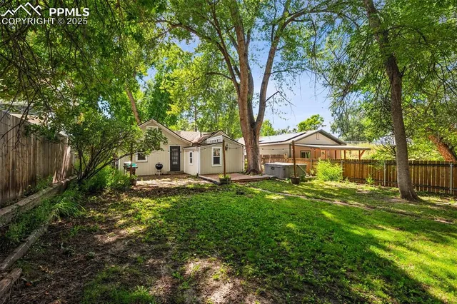 a front view of a house with yard and green space