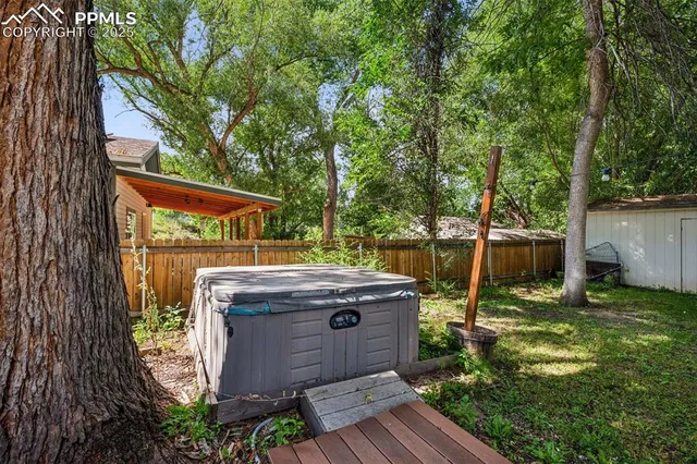 a backyard of a house with table and chairs