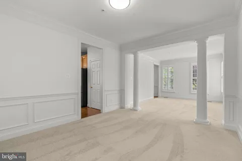 a kitchen with stainless steel appliances granite countertop a refrigerator a sink dishwasher a stove and white countertops with wooden floor