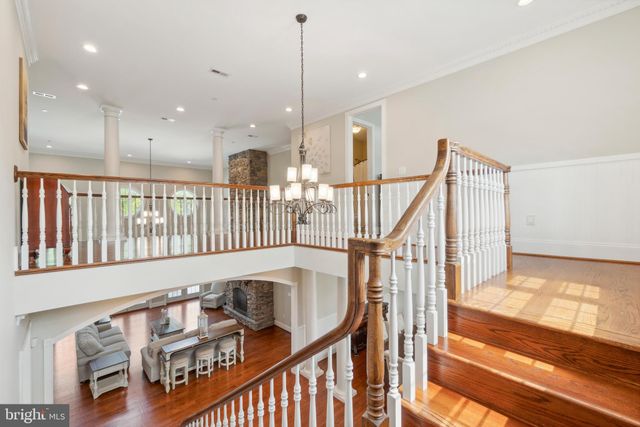 a view of a white house with swimming pool and porch