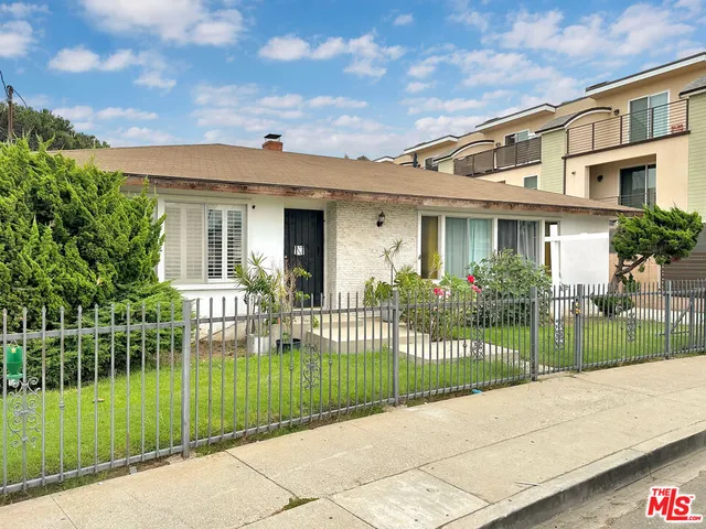 a view of a house with a garden and plants