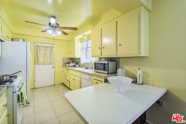 a bed room with a bed mirror and a chair