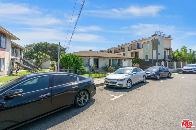 a couple of cars parked in front of a house