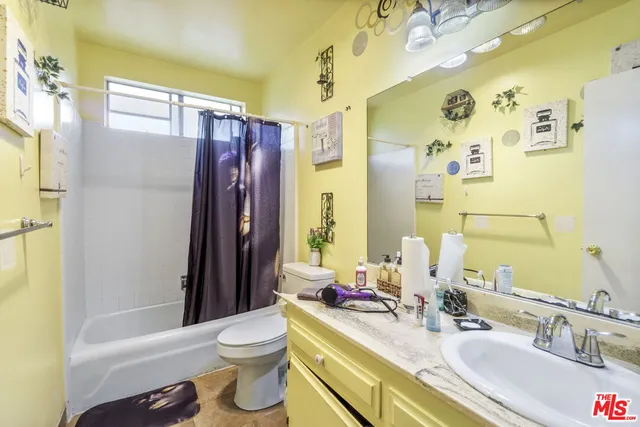 a bathroom with a sink mirror vanity and toilet