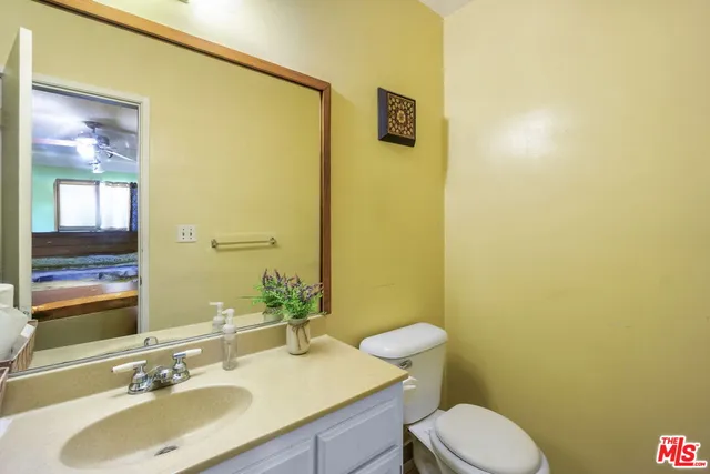 a bedroom with a bed dresser and a window