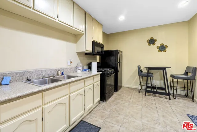 a spacious bedroom with a large bed and a flat screen tv