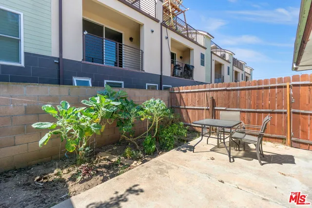 a view of a patio with table and chairs and potted plants