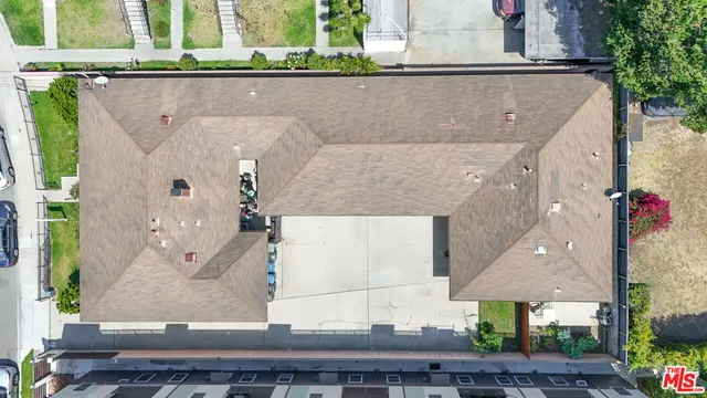 an aerial view of residential houses with outdoor space