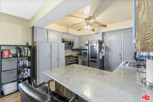 a kitchen with refrigerator and cabinets