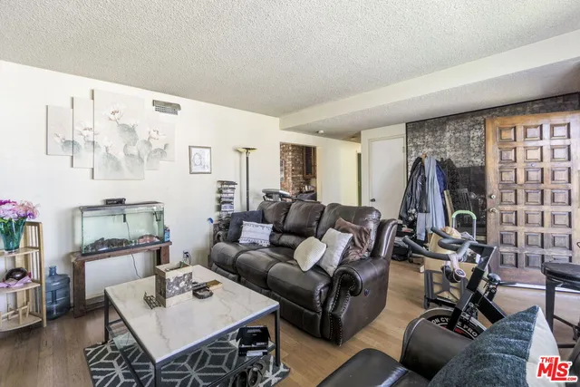 a living room with furniture a flat screen tv and a large window