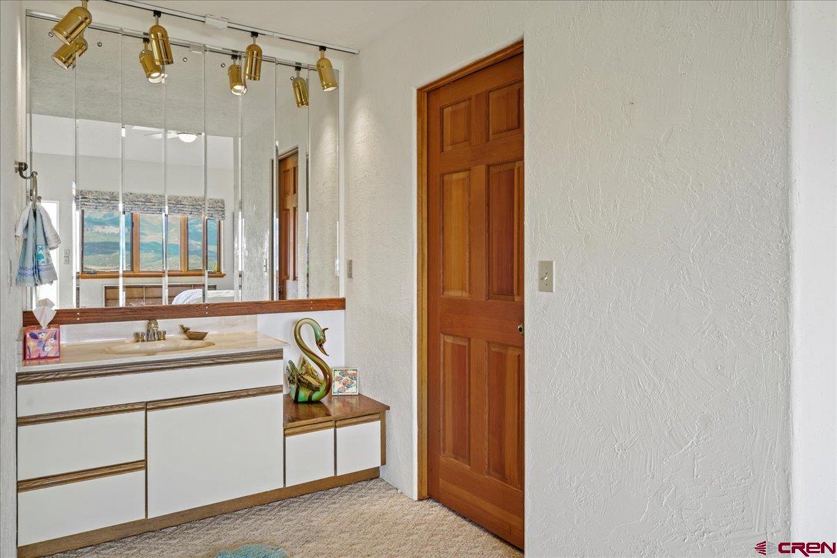 12979 County Road 1 Ridgway, CO 81432 - Photo 19 of 35 a bathroom with a sink and a mirror