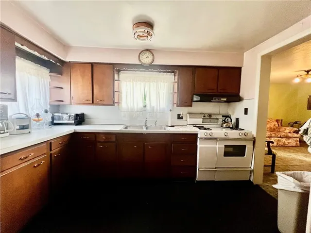 a kitchen with a sink stove and cabinets
