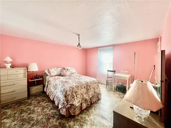 a bedroom with a bed and a mirror