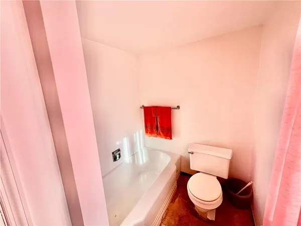 a white toilet sitting next to a sink