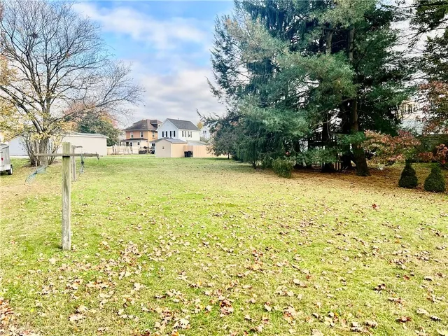 a view of yard with swimming pool and green space
