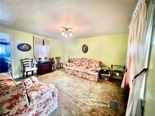 a bedroom with a bed and dresser with mirror