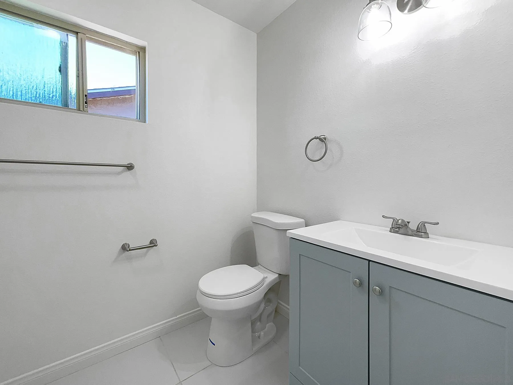 9820 St George Street Spring Valley, CA 91977 - Photo 15 of 23 a white toilet sitting next to a bathroom sink