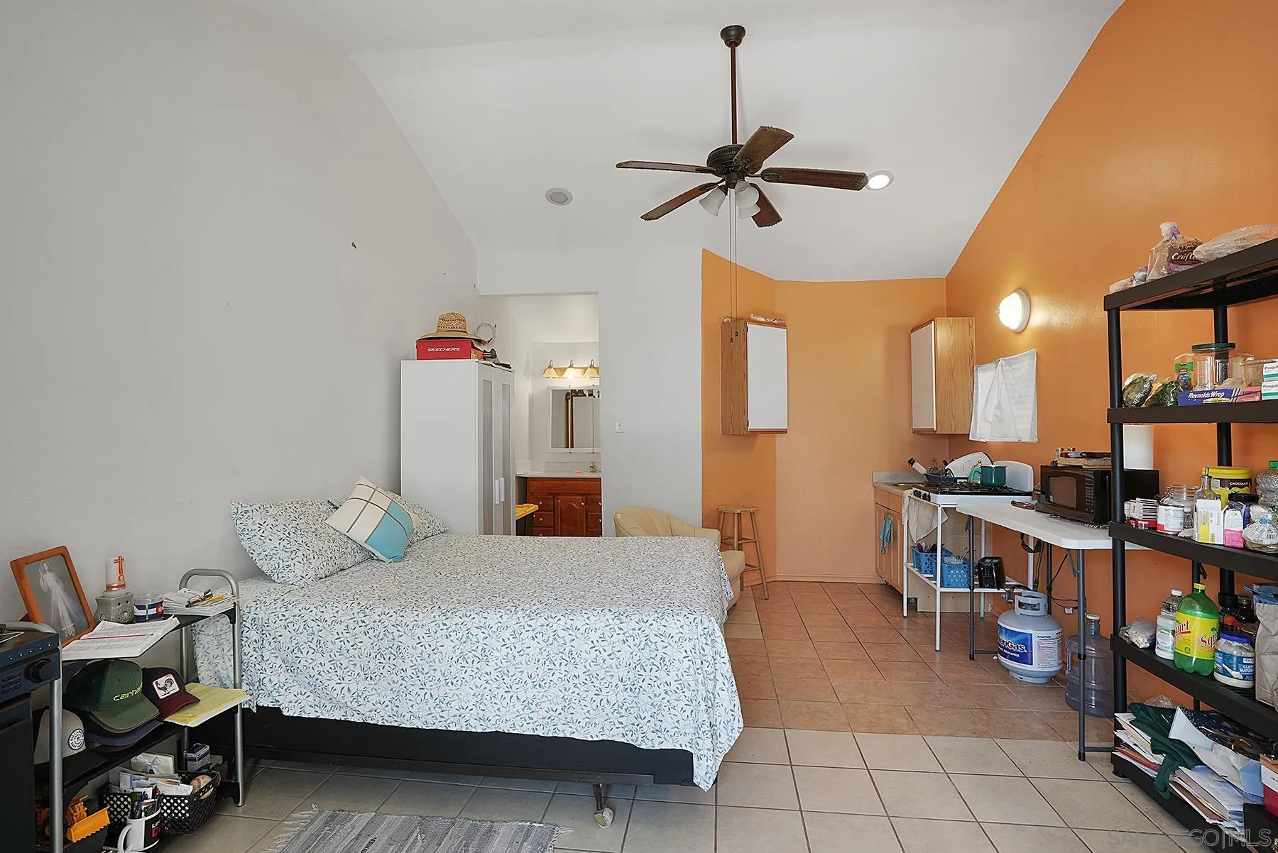 9820 St George Street Spring Valley, CA 91977 - Photo 18 of 23 a bedroom with furniture and a book shelf