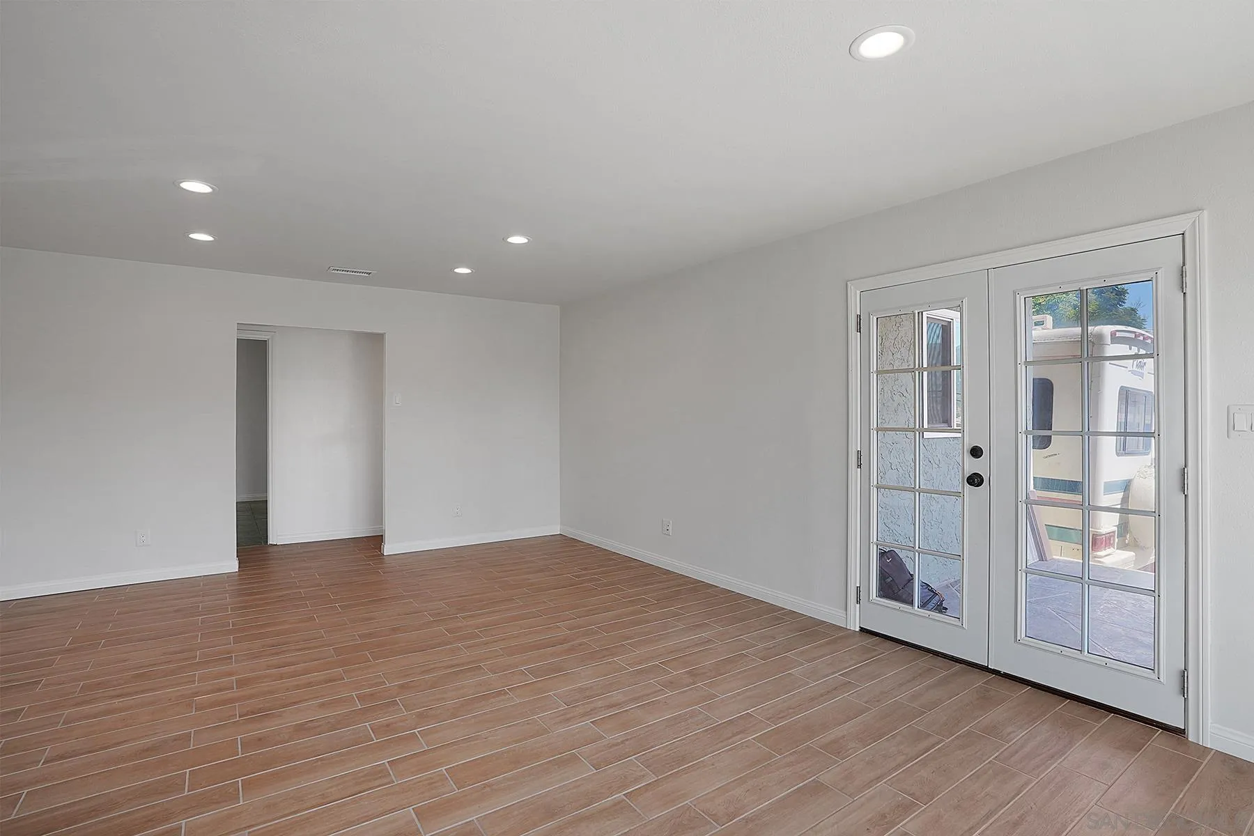 9820 St George Street Spring Valley, CA 91977 - Photo 7 of 23 a view of an empty room with wooden floor and a window