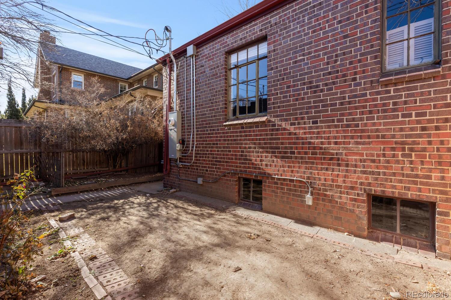 390 Dexter Street Denver, CO 80220 - Photo 24 of 30 a backyard of a house with a large tree