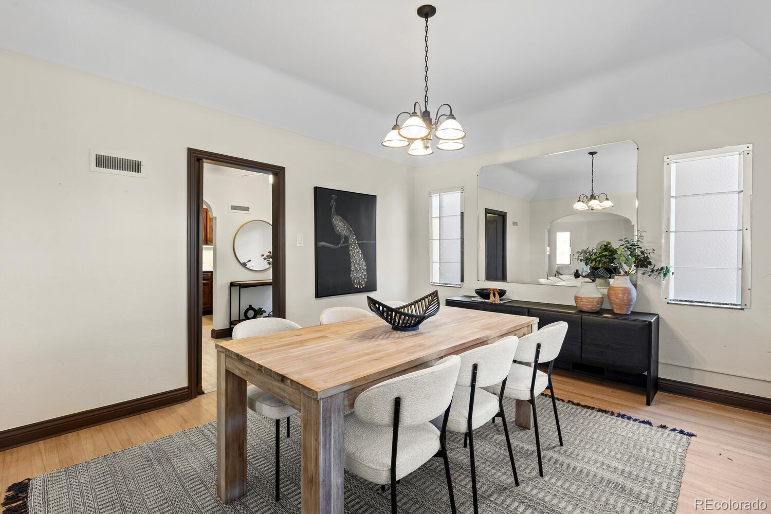 390 Dexter Street Denver, CO 80220 - Photo 9 of 30 a view of a dining room with furniture window and wooden floor
