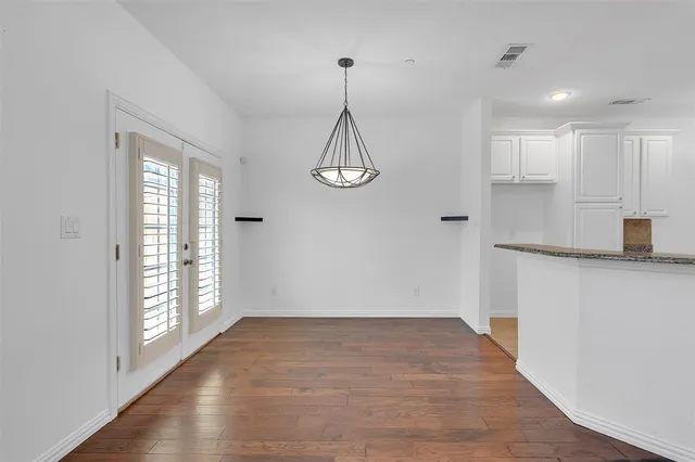 a view of a room with wooden floor and windows