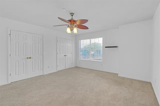 a bathroom with a granite countertop sink a mirror and a bathtub