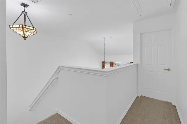 an empty room with a window and a ceiling fan