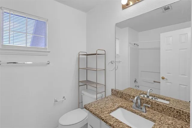 a backyard of a house with outdoor seating and barbeque oven