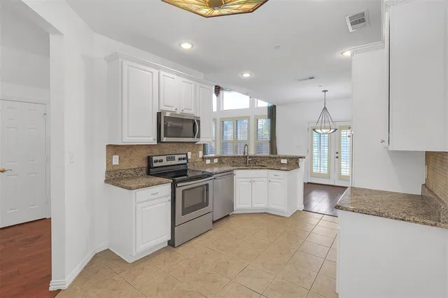 a kitchen with a stove a sink and a microwave