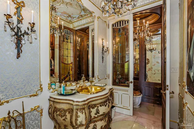 a bathroom with a granite countertop sink mirror vanity and toilet
